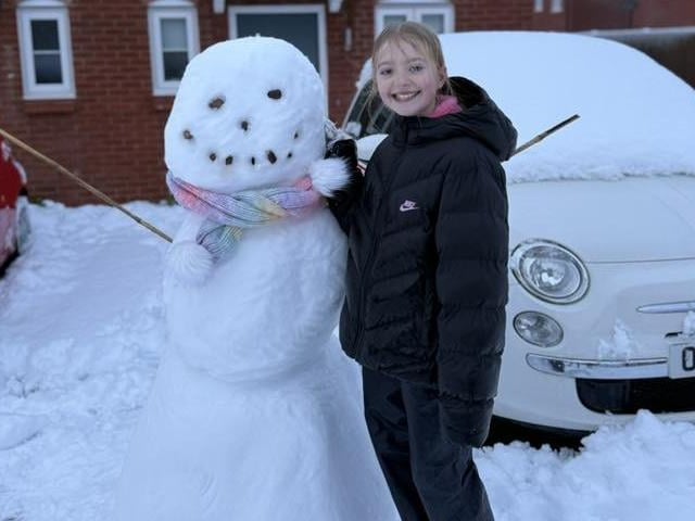 Snow means fun for many youngsters and this girl wasted no time in building a cracking snowman in Sutton.