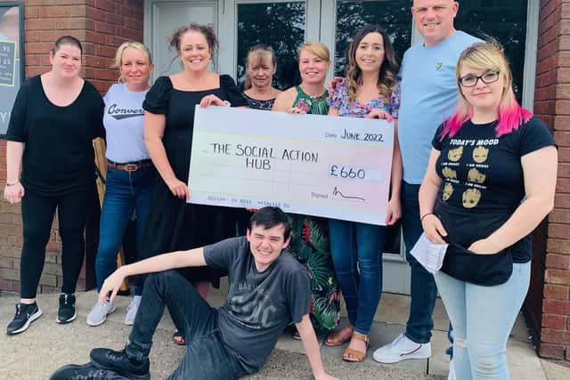Claire Penny of The Social Action Hub and Steven Carr, Laura Carr and Vicky Geary pose with the The Sherwood Pub team to celebrate fundraising success.