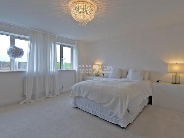 The master bedroom at the £575,000 house is a majestic retreat, with windows overlooking the back garden and beyond.