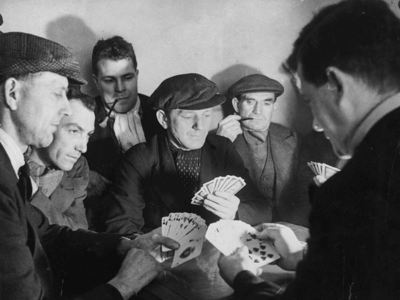 Some of the 1,000 men who have been on strike from Haworth Colliery for nine weeks, playing a game of cards to while away the time, circa 1950.