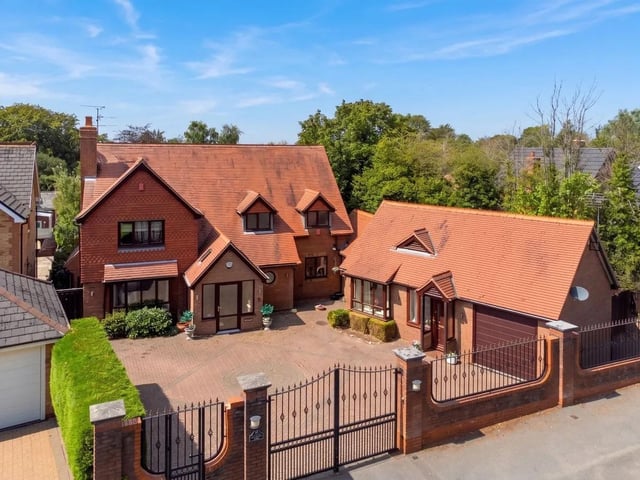 The property is approached via an electric-gated driveway that provides secure off-road parking for multiple vehicles and an excellent degree of privacy. This leads to a garage fitted with an electric door, power, and lighting.