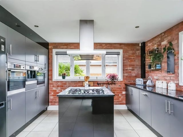 The open plan kitchen features a range of integrated appliances.