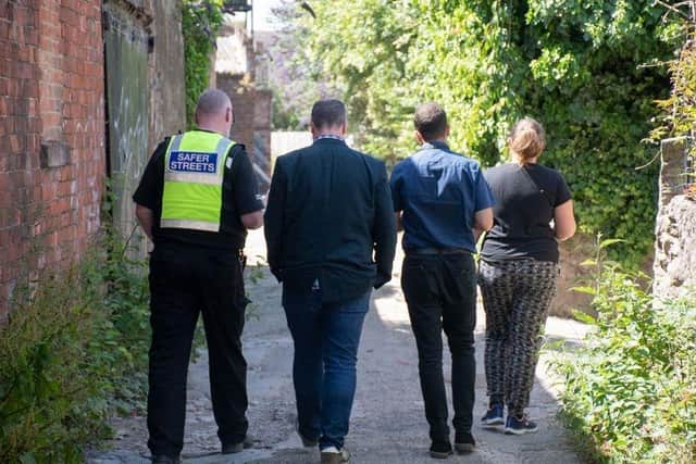 Councillors and officers inspect one of the alleyways set for closure.