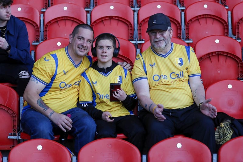 Mansfield Town fans watch the 2-2 draw at Doncaster on 15 August 2023.
