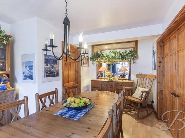 For added versatility, the dining room, accessible from the hallway, features elegant double doors leading into the spacious living room — ideal for both formal dinners and relaxed family gatherings.