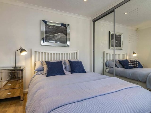 Homely furnishings abound in the four bedrooms, which are all presented to a high standard. This one boasts striking wardrobes.