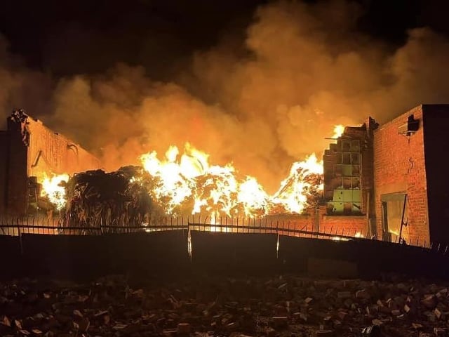 Walls and the roof have collapsed on this Savanna Rags building as the fire continues to rage.