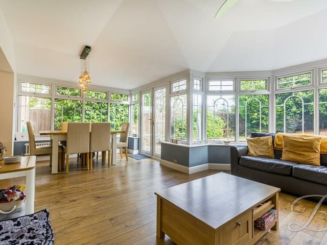 The open-plan conservatory/diner is a marvellous room, full of light thanks to wonderful windows. With a comfortable living area, it is a terrific sociable space too for entertaining family and friends