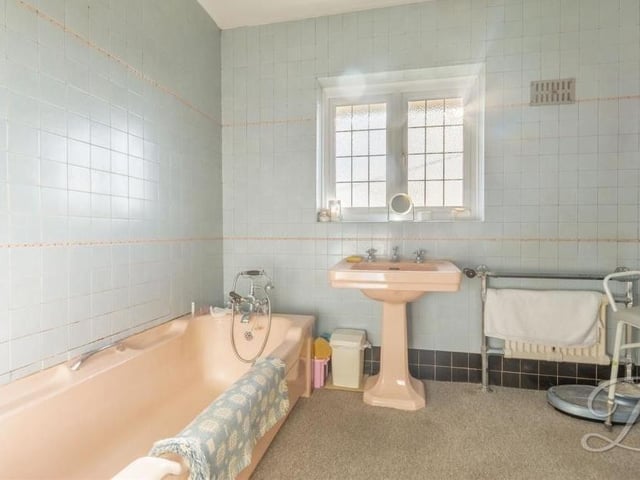 At the opposite end of the first floor to the shower room is this family bathroom. It boasts a fitted bath with shower attachment, hand wash basin, storage cupboard and full-height tiling. A separate WC is not far away.