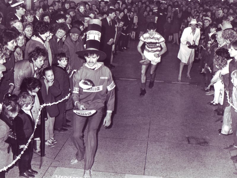 Action from the pancake race in the Arndale Centre between the Arndale managers, Arndale staff and Doncaster Rovers in February 1985.