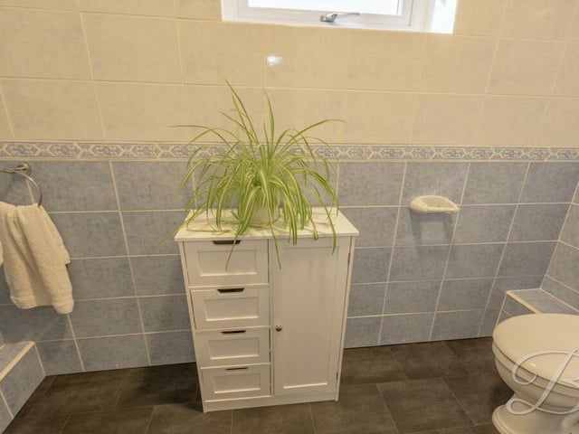 Across the landing from the family bathroom is this separate toilet, fitted with a low-flush WC and wash hand basin.