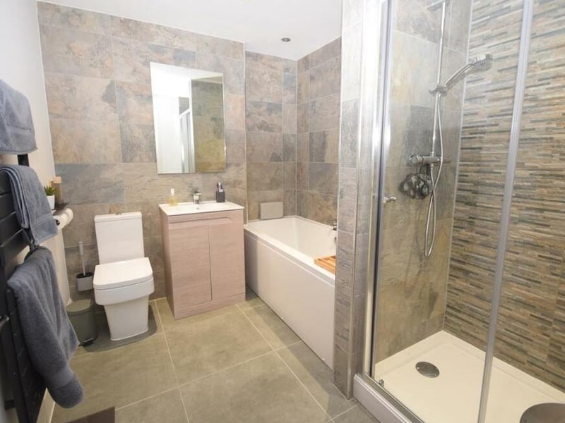 The family bathroom on the first floor has a bespoke design featuring a top-quality suite. It comprises a double-ended bath, separate shower cubicle with dual showers, low-flush WC and wash basin in vanity unit. There are also a heated towel-rail and tiled flooring.
