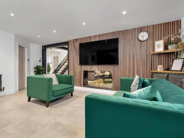 Like the lounge, the living/dining area boasts a wooden feature wall, with a double-sided bioethanol living-flame-fire that has an additional scent option.