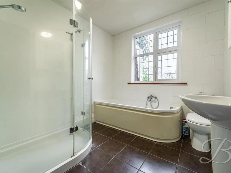 Four piece suite including a hand wash basin, low flush WC, shower and a bath. Window to the rear elevation.