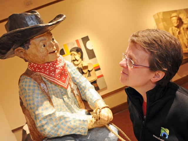 Mansfield Museum's Jodie Henshaw takes a good look at a model by the artist Phillip Cox, who has a papier mache sculpture exhibition on display.