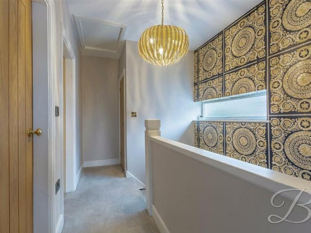 At the top of the stairs is the first-floor landing, with fitted carpets. It leads to the remaining three bedrooms and a family bathroom.