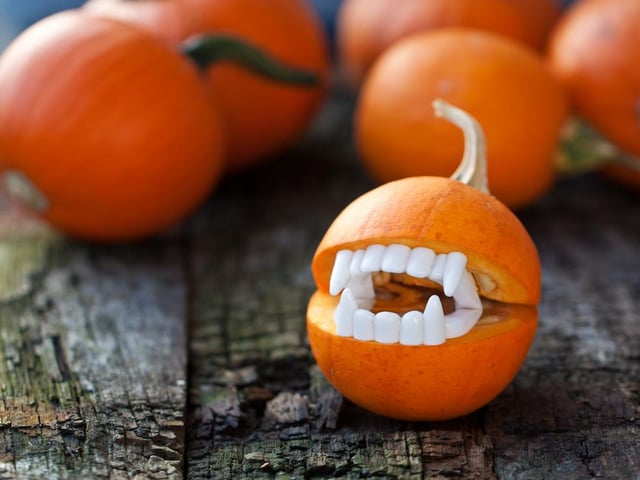 If you have a spare pair of vampire teeth lying around as part of your Halloween costume, you can make a cute little vampire pumpkin.