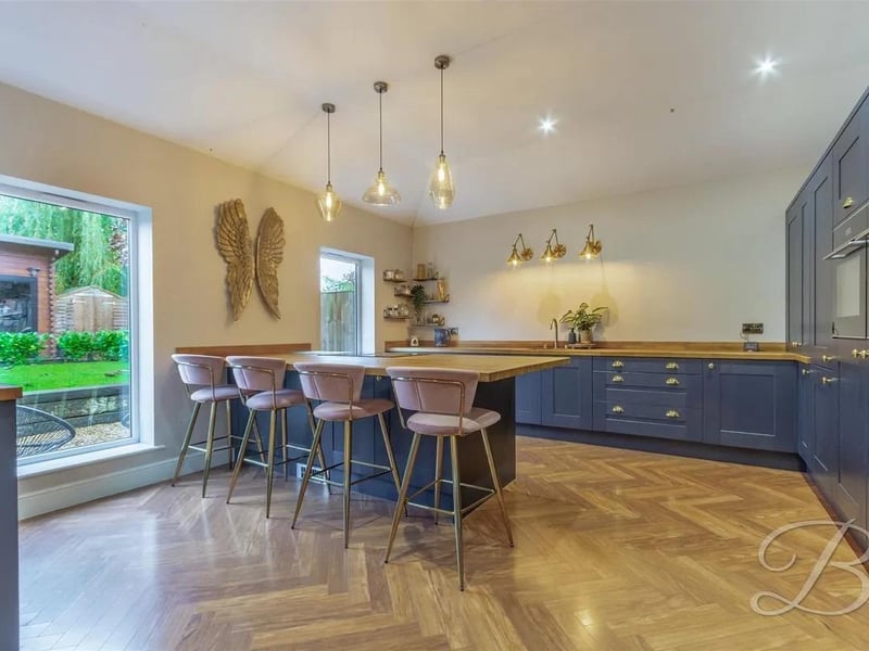 The ground floor of this remarkable home boasts an exceptional open-plan layout, seamlessly integrating the kitchen, dining area, and living room