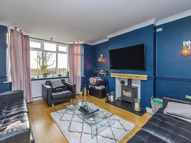 Let's start our tour of the Annesley Lane house in this large living room, with its cosy seating space in front of a log burner.