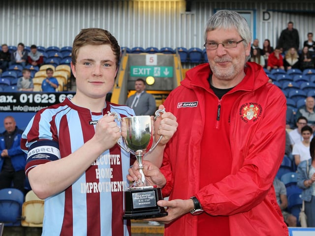 Underwood Villa skipper Alex Nunn receives the U16 trophy from Chad Youth League vice chairman john Holmes.