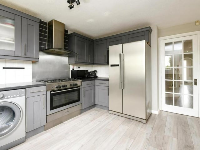 Next to the dining room is this classy kitchen, which screams contemporary, doesn't it? Integrated appliances and storage units galore.