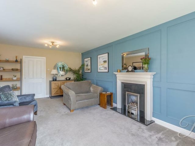 At the heart of the living room is an eyecatching feature fireplace.