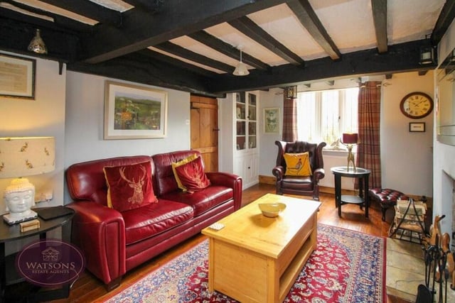 Our photo gallery begins in the lounge, which is brimming with character and charm, thanks largely to its feature ceiling beams. There are uPVC double-glazed windows to the front and side of the property.