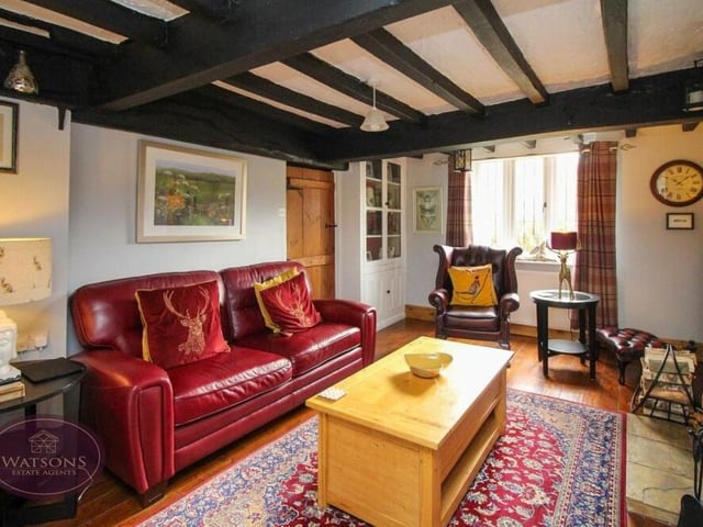 Our photo gallery begins in the lounge, which is brimming with character and charm, thanks largely to its feature ceiling beams. There are uPVC double-glazed windows to the front and side of the property.