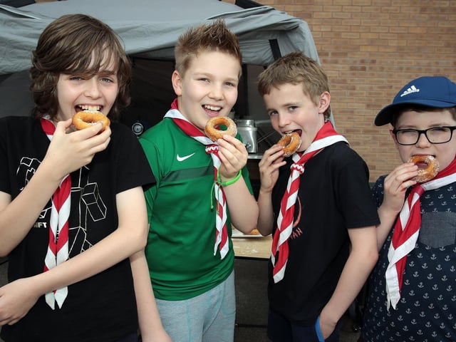 Euan Waugh, Oliver Harvie, Jonathan Tempest-Mitchell and Seth Vickers enjoy the free doughnuts made by the 4th Woodhouse scout leaders, Mansfield, United Kingdom, 22nd April 2018. Photo by Glenn Ashley.
