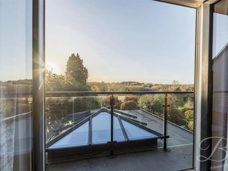 Bedroom two features French patio doors which provide access out onto the balcony which overlooks the rear garden.