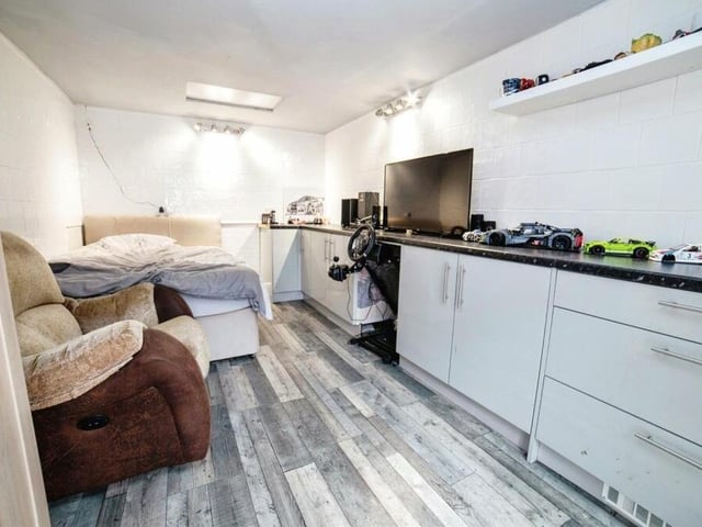 The rear garden does contain a garage but, previously used for a catering business, it has currently been converted into another bedroom. It is equipped with tiled walls, laminate flooring, fitted units and French doors.