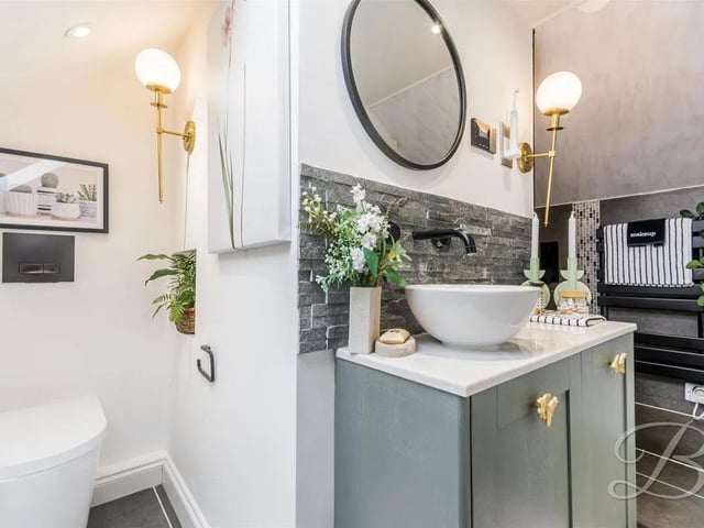 With a walk in shower with rainfall shower head, low flush WC, vanity sink with mixer tap, tiled flooring, central heating radiator, electric toothbrush charger and velux window. The shower room is also fitted with a built in radio system that consists of speakers and a control point.