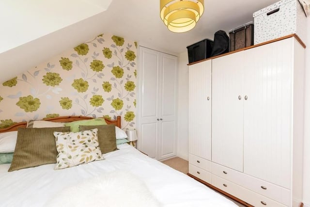 Here is the third of the four bedrooms at the £400,000 family home. It is smaller than the first two, but there is still plenty of storage space.