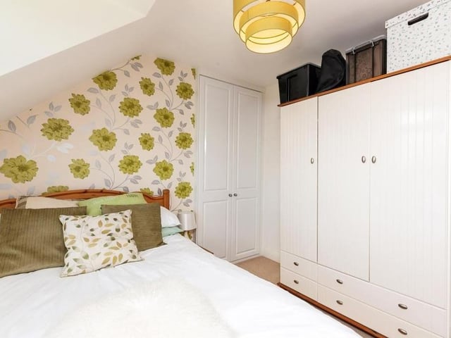 Here is the third of the four bedrooms at the £400,000 family home. It is smaller than the first two, but there is still plenty of storage space.