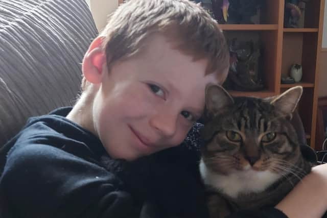 James Telford aged 10 with the family's pet Bandit the cat
