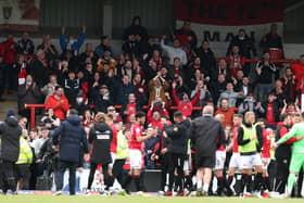 Morecambe fans celebrate their side's play-off semi-final victory overTranmere Rovers.