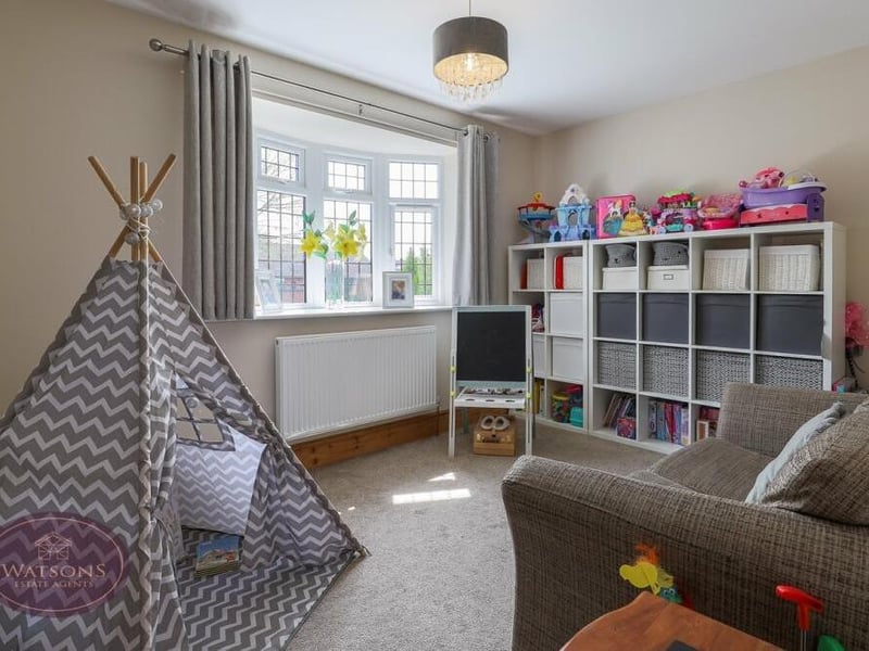 This versatile second sitting room is currently being used as a play room for the kids.