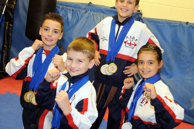 Four pupils whohave won 13 golds and six silver medals at the World championships in Italy in 2008
Pictured are front Kane Williams age 8 who won 8 Golds.left Dainal Maher, age 10 who won 4 Golds & Two Silver, back Michell Duncan, age 10 who won 2xgolds & 1x Silver, & right Jade Maltby, age 8 who won 2x Golds & 3 Silver, with Coach Terry Johnson holing the flag back left.