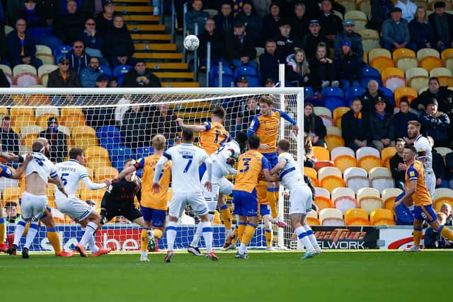 Mansfield Town defender Elliott Hewitt heads clear against Tranmere Rovers. Pic : Chris Holloway / The Bigger Picture.media