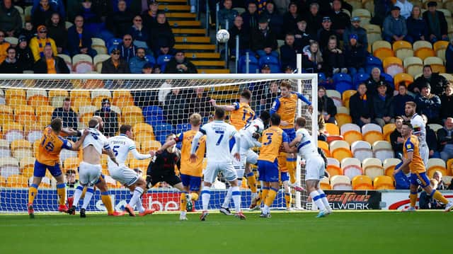 Mansfield Town defender Elliott Hewitt heads clear against Tranmere Rovers. Pic : Chris Holloway / The Bigger Picture.media