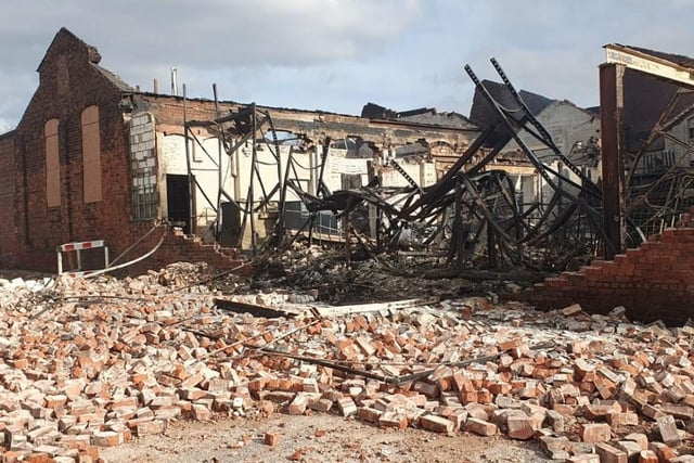 The aftermath of the fire at Savanna Rags, as fire crews remain on the scene at Forest Road.