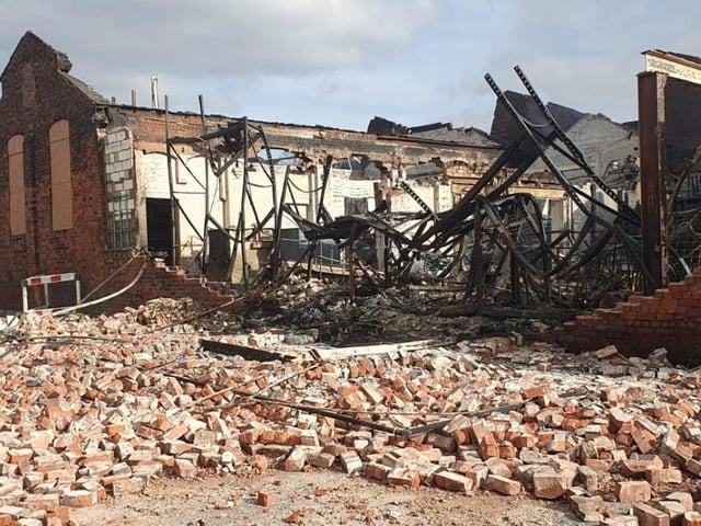 The aftermath of the fire at Savanna Rags, as fire crews remain on the scene at Forest Road.