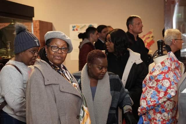 Residents make their way around the Windrush exhibition.