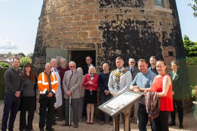 Members of Sutton Heritage Society with Councillors outside Lindley's Windmill. (Photo by: Ashfield Council)