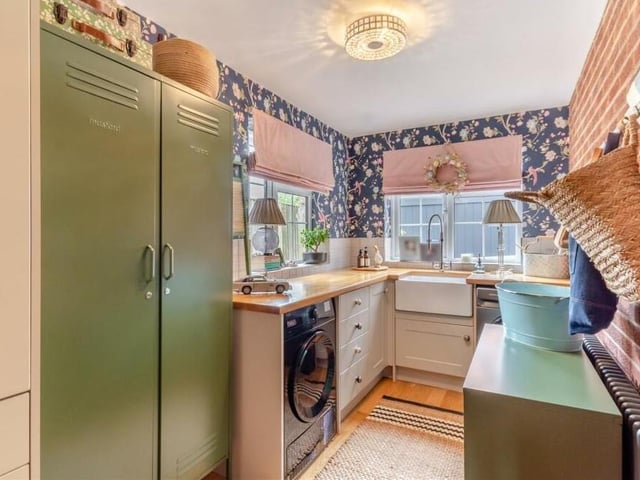 Not far from the kitchen is this useful utility room, which has plumbing for a washing machine and space for a tumble dryer. Modern shaker cabinets comprise wall cupboards, base units and drawers, with wood work surfaces and an inset Belfast sink.