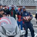 The team poses with Mansfield superheroes at the event.