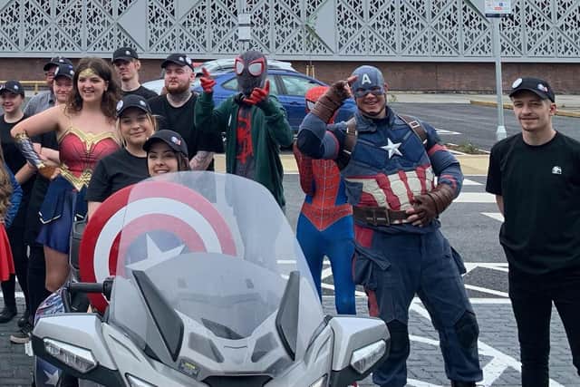 The team poses with Mansfield superheroes at the event.