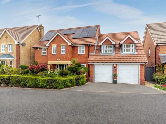 The last photo of our gallery shows the double-width driveway at the front of the house which leads to an integral double garage with remote-controlled electric doors.