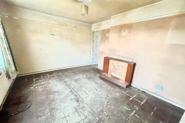Here is the first of two reception rooms on the ground floor of the Armstrong Road property. With its fireplace, it lends itself well to being turned into a living room.