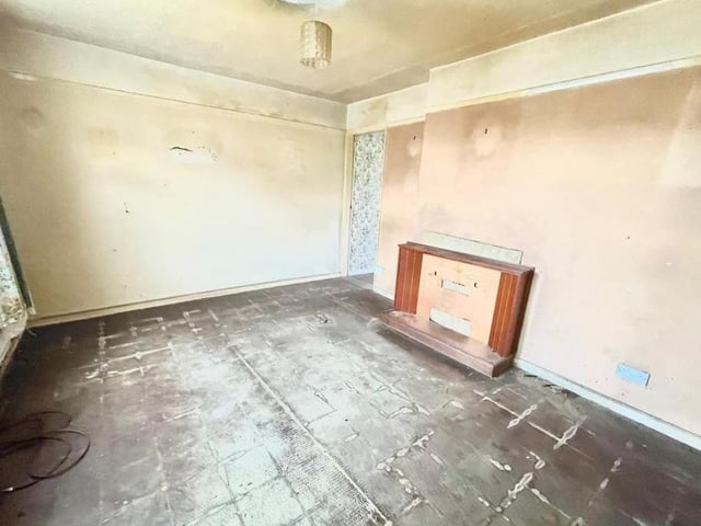 Here is the first of two reception rooms on the ground floor of the Armstrong Road property. With its fireplace, it lends itself well to being turned into a living room.